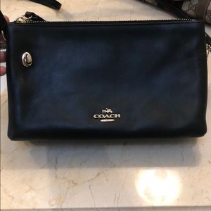 Small black Coach crossbody purse.